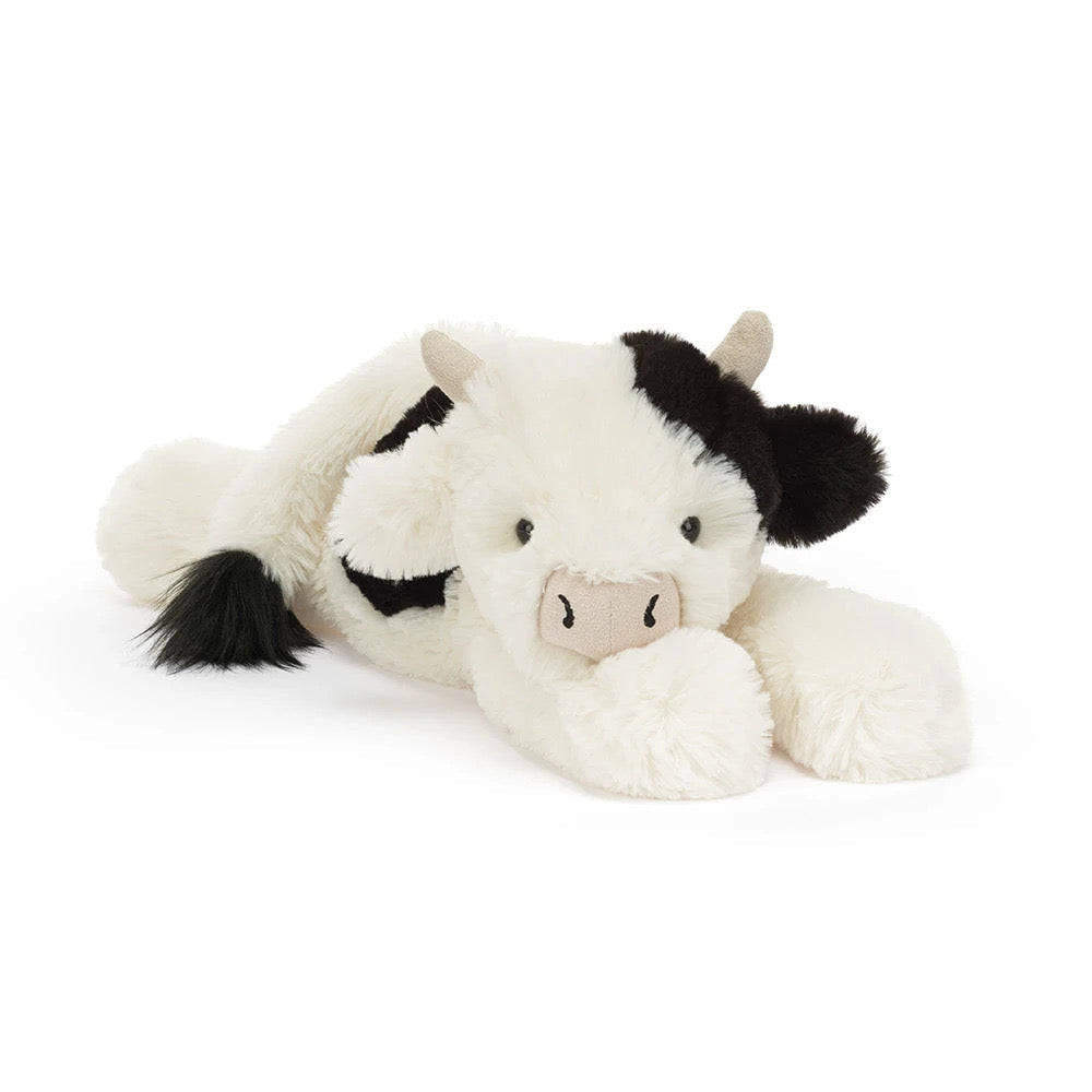 Smudge Cow — soft black and white cow plushie lying down, from Leona Bangladesh